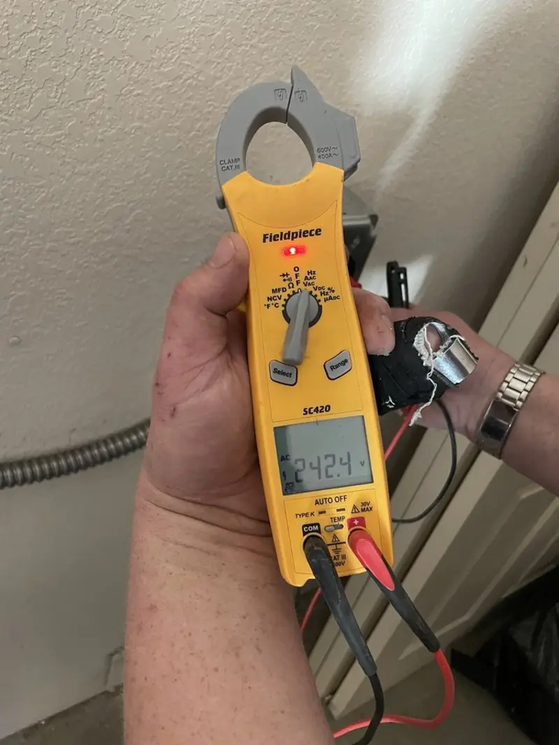 Voltage testing with clamp meter during Ceiling Fan Installation in Butler